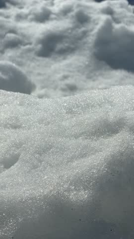 Snow-covered landscape with ice formations and distant mountains