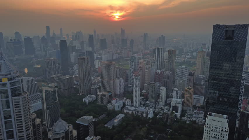 Aerial view of Bangkok city skyline during sunset. Urban skyscrapers and office buildings in business district, Thailand, 4k