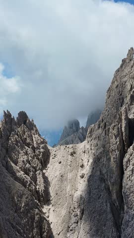 Towering mountain peaks shrouded in mist, a dramatic and rugged natural landscape.