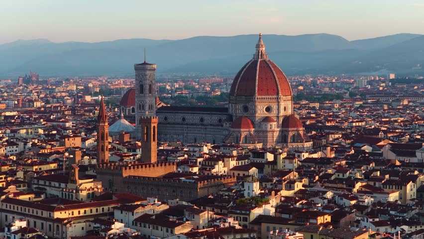 drone shot of Italian city of Florence at sunset, famous Renaissance cathedral of Santa Maria del Fiore in Florence, tourism in Italy