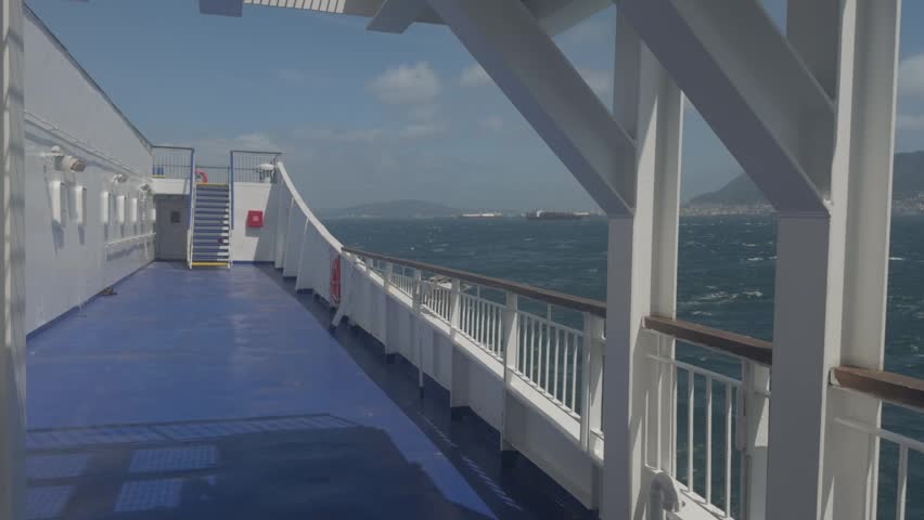 Ferry boat departing harbor leaving water wake on sea under daylight