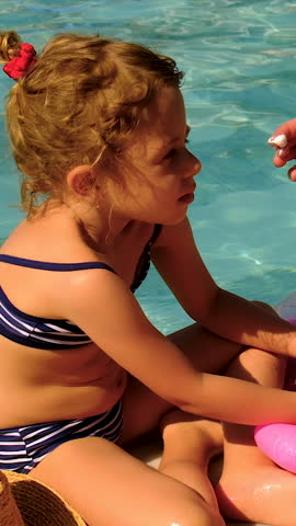 The child has sunscreen on his face. Selective focus.