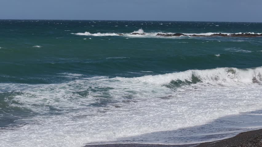 Powerful ocean waves crashing on a rocky shoreline