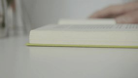 One  opened book with green hardcover  on white table , educational subject or leisure time - Powered by Shutterstock - Get 15% off with code: PIKWIZARD15