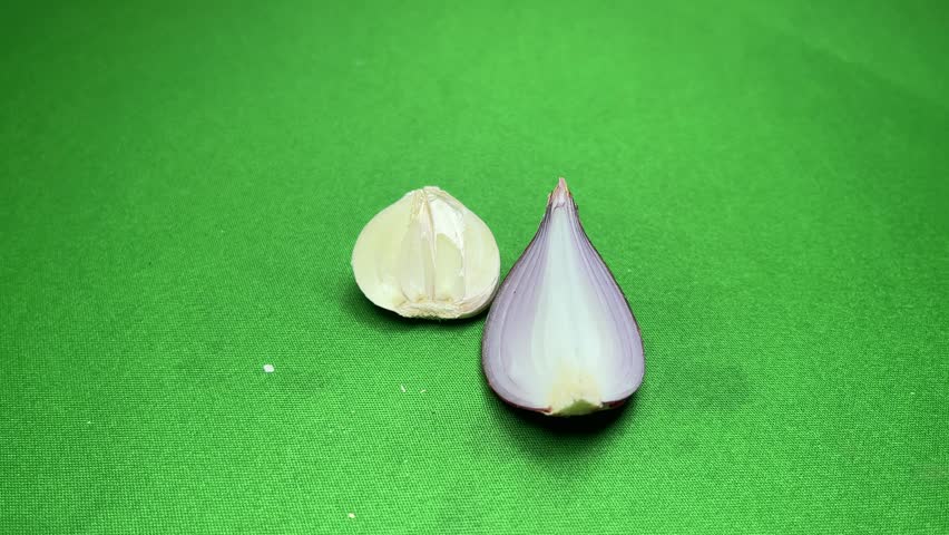 Fresh Peeled Garlic Clove and Red Onion Slice Isolated on Green Screen Chroma Key Background