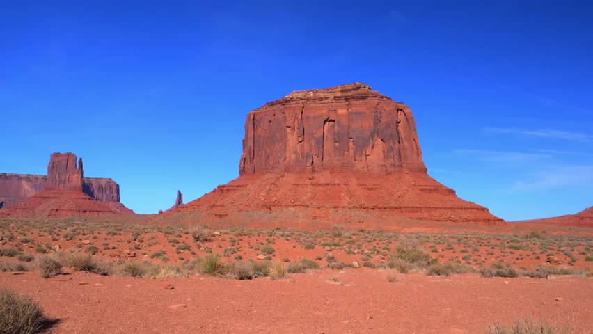Monument Valley, located on the Arizona-Utah border in the United States. The red rock formations, known as buttes, are remnants of ancient seabeds and sedimentary rock layers composed primarily of Navajo Sandstone. The area is sacred to the Navajo Nation, who call it Tse Biiʼ Ndzisgaii, meaning "Valley of the Rocks".
