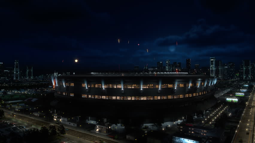 Fireworks Explode Over a Lit Arena at Night During a Championship Ceremony, Concert, or Tournament Event. Big Stadium for Sports, Live Entertainment. Aerial Wide Arc Shot