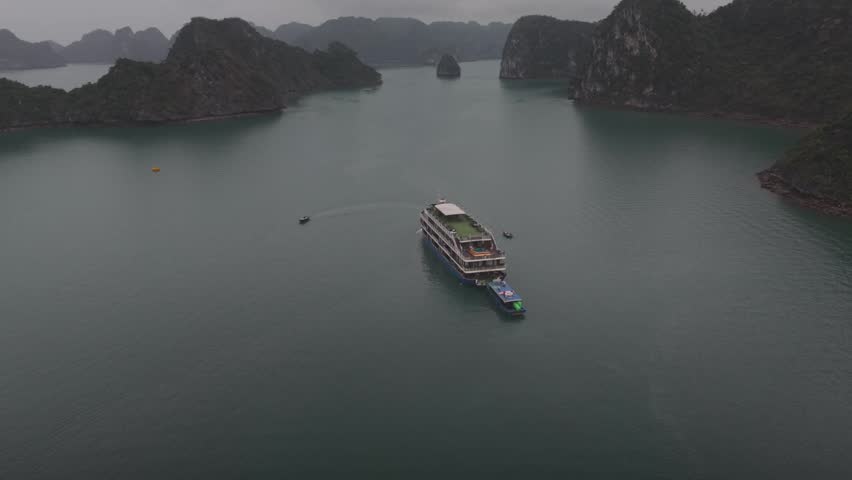 Aerial view of limestone rock formations in a foggy bay.
