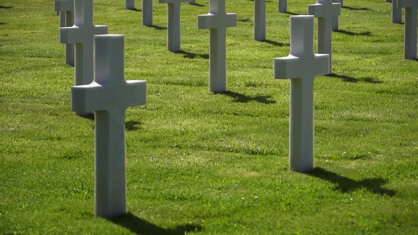 White grave crosses at American war cemetery honoring military service. Memorial Day concept in military memorial park
