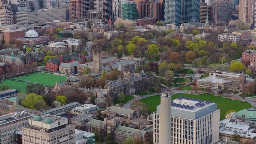 University of Toronto St. George campus showing gothic revival architecture, modern buildings, green spaces, with modern Toronto city skyline background
