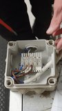 Electrical service engineer inspecting wiring inside a junction box and testing circuits for continuity and voltage during maintenance and fault diagnosis - Powered by Shutterstock - Get 15% off with code: PIKWIZARD15