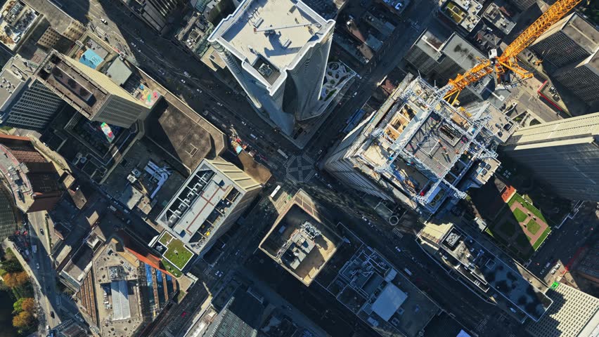 Top down aerial of financial district with skyscrapers, urban canyons, vehicle traffic creating a captivating city pattern in North America