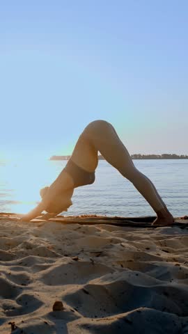Barre workout. stretching outdoors. yoga beach. Athletic young woman is doing exercises on mat, at the beach during sunset or sunrise. Fitness training outdoors. Fitness, ballet, sport, yoga