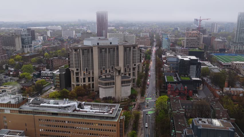 Robarts Library and University of Toronto campus on a cloudy and moody day showing urban architecture, towers and skyscrapers from above