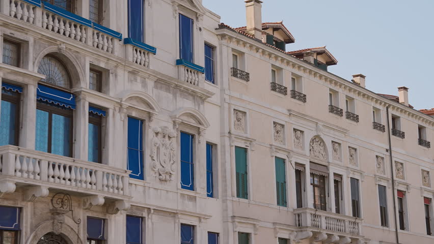 Typical Venetian hotels building facade with decorative elements and architectural details. Classic Italian atmosphere.