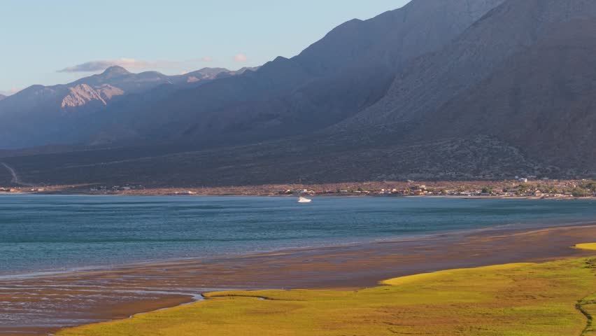Aerial shots show Bahia de Los Angeles in Baja California as the sun sets, highlighting the land, water, and nearby mountains.