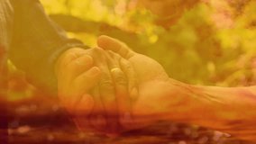 Framing clasped hands, Senior couple holding, adjusting grip while warm overlay rising for health. Nature, garden, foliage, bokeh, goldenhour, togetherness, companionship - Powered by Shutterstock - Get 15% off with code: PIKWIZARD15