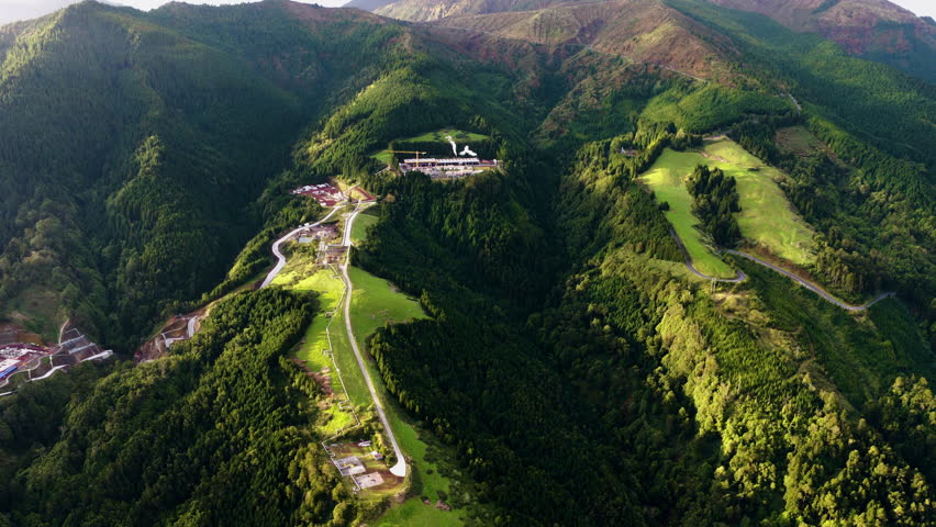 The Ribeira Grande Geothermal Power Station Facility Over Green Lush Mountain Landscape On São Miguel Island In The Azores, Portugal. Aerial Shot