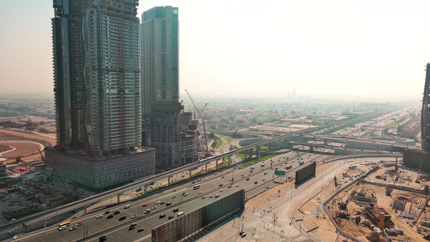 Dubai, United Arab Emirates: Aerial view of capital city of Emirate of Dubai, resort city and modern global business hub in Persian Gulf - landscape panorama of Arabian Peninsula from above