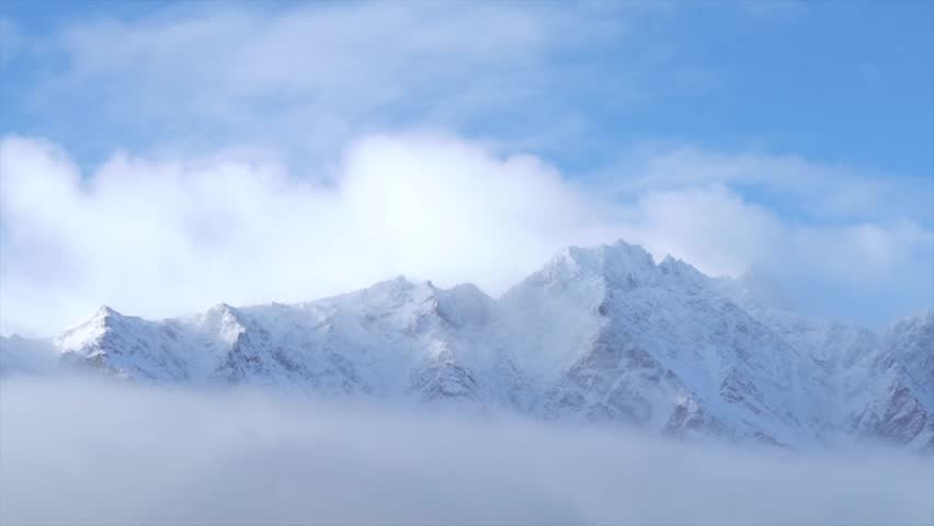 Winter The Remarkables Ski Resort snow covered peaks morning low cloud fog sunny blue sky Queenstown New Zealand South Island Glenorchy landscape Kawarau Mountain Range Crown Range Coronet Peak