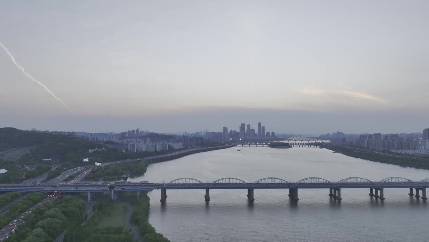 Aerial view of Han River at sunset from Dongjak, featuring subway trains on the bridge, Seoul, South Korea.
