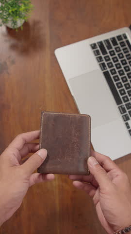 A person holding an empty wallet with no money inside, illustrating financial hardship, economic struggle, debt, and personal finance challenges in everyday life.