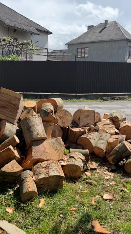 firewood delivery being carried into countryside yard