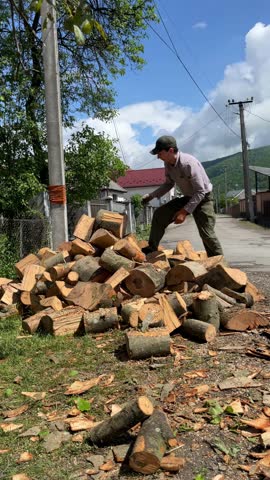 delivery firewood being moved by young man outdoors