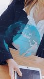 Vertical video: Woman touching tablet, activating holo globe over forearm, showing regions for tech. Holographic, augmented, reality, display, interface, executive, vertical video - Powered by Shutterstock - Get 15% off with code: PIKWIZARD15
