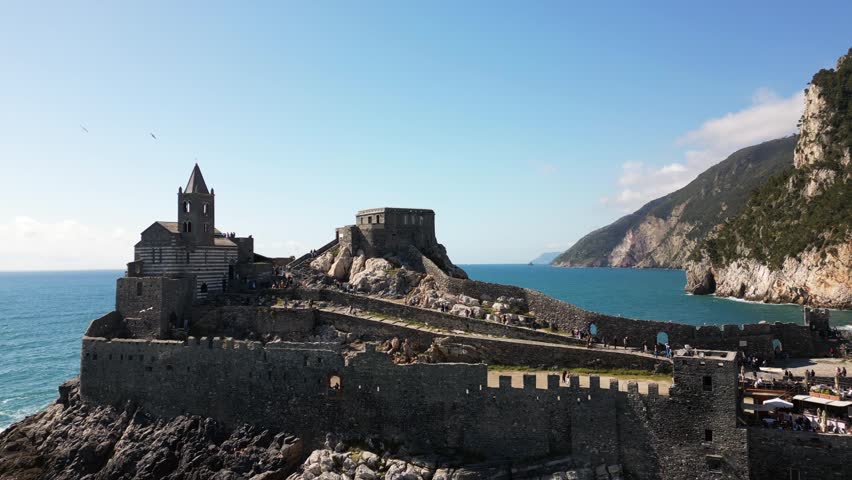 Italy, Liguria, The Church of San Pietro in Portovenere in the province of La Spezia, perched on a rocky spur overlooking the sea, is a Gothic-Genoese jewel from the 13th century - drone view , tourist attraction destination sightseeing