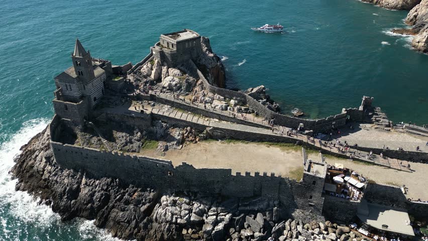 Italy, Liguria, The Church of San Pietro in Portovenere in the province of La Spezia, perched on a rocky spur overlooking the sea, is a Gothic-Genoese jewel from the 13th century - drone view , tourist attraction destination sightseeing
