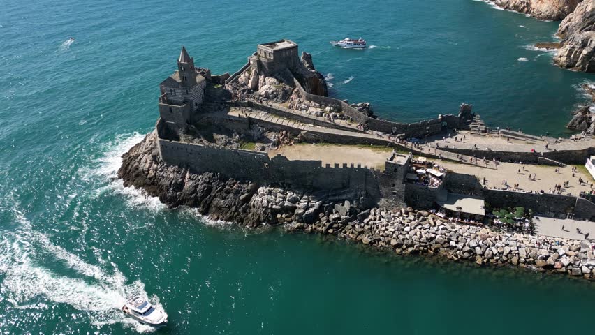 Italy, Liguria, The Church of San Pietro in Portovenere in the province of La Spezia, perched on a rocky spur overlooking the sea, is a Gothic-Genoese jewel from the 13th century - drone view , tourist attraction destination sightseeing