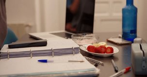 Study desk: The scene shows a person's hand on a study desk filled with stationery and snacks, creating an atmosphere of focused study and dedication to learning.	 - Powered by Shutterstock - Get 15% off with code: PIKWIZARD15
