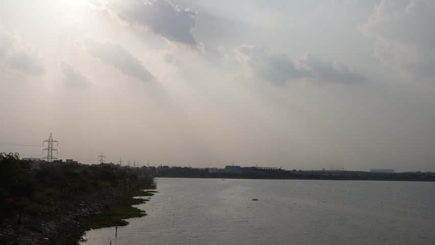 Wide river landscape under cloudy sky