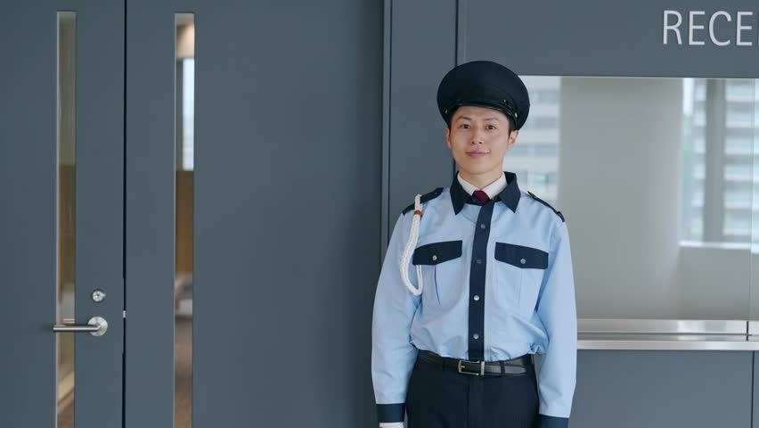 A male security guard salutes at the entrance.