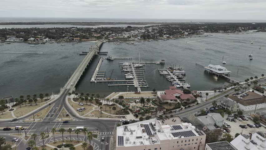 Aerial view of the Bridge of Lions spanning the Matanzas River with boats docked at the marina in St. Augustine, Florida, United States.