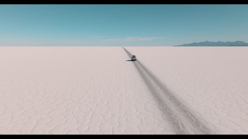 4x4 vehicle driving across the Uyuni salt desert in Bolivia, crossing vast white plains under a clear sky. Minimalist landscape with endless horizon and remote travel adventure.
