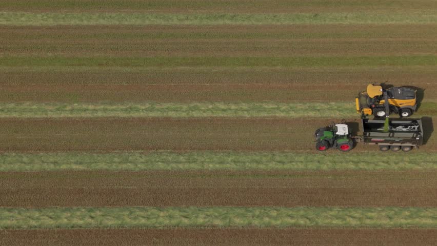 Agricultural tractors harvesting grass aerial view Italy farming