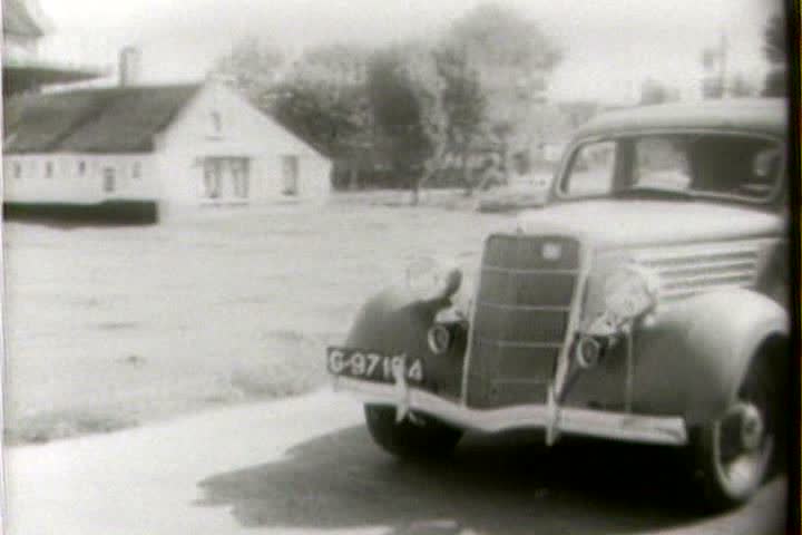 1950s - New Fords pass a Holland windmill in 1954.