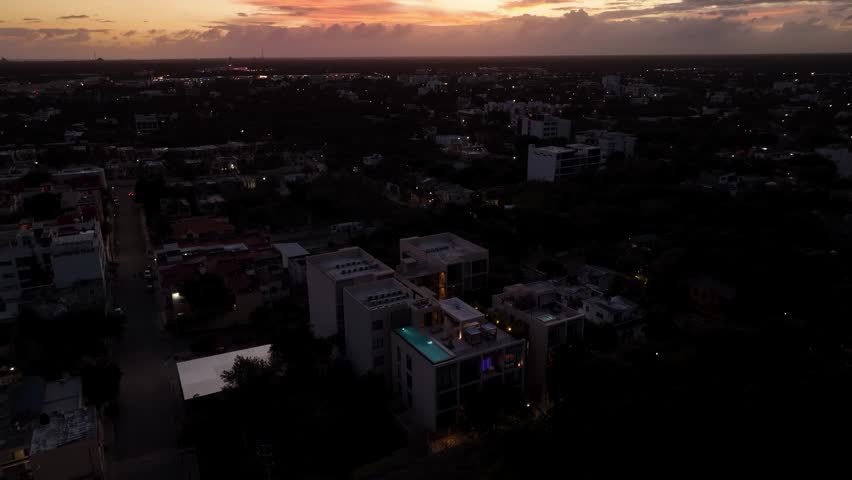 Aerial view of Playa del Carmen city at sunset under dramatic clouds