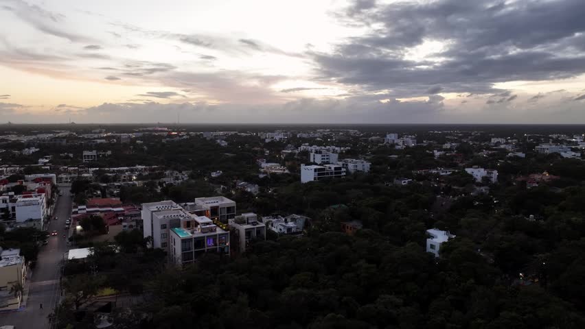 Aerial view of Playa del Carmen city at sunset under dramatic clouds