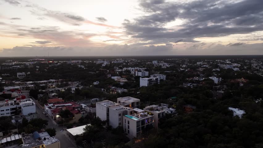 Aerial view of Playa del Carmen city at sunset under dramatic clouds