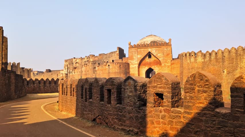 Fort Gumbad Darwaza dome with side wall and road at bidar, karnataka, india. day time, hand held shot, trucking shot, 4k.