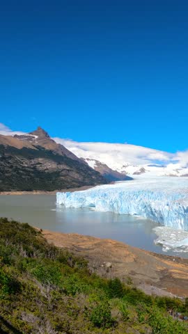 Wide angle view of the Perito Moreno Glacier ice wall and surrounding mountains near Lago Argentino in Los Glaciares National Park, Patagonia, Argentina.