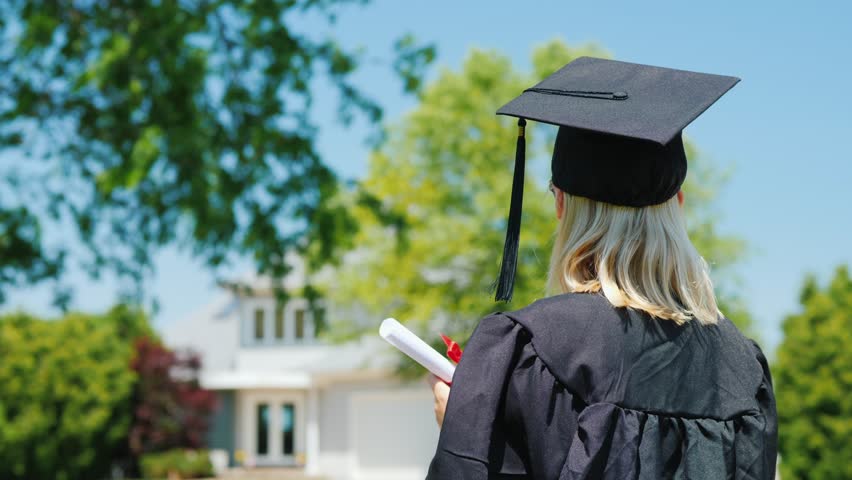 Graduation day celebration, back view of student, outdoor motion.