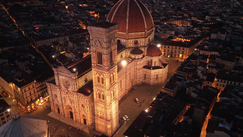 night drone shot of iconic renaissance cathedral in Florence, Santa Maria del Fiore cathedral aerial view with evening illumination, travel in Tuscany, Italy