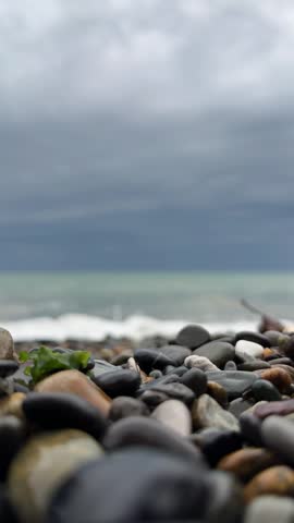 Rocky shoreline with waves and overcast sky