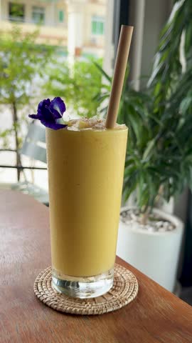Closeup of Drinking a Mango Smoothies