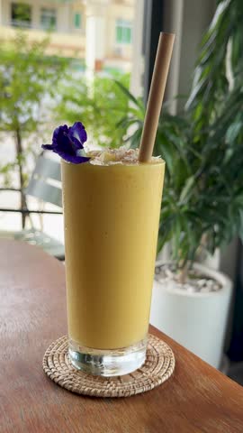 Closeup of Drinking a Mango Smoothies