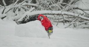 Child in a red jacket playfully leaning backward over the top of a giant snowball, then rolls upside down - Powered by Shutterstock - Get 15% off with code: PIKWIZARD15